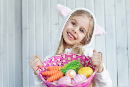 Little girl with Easter wicker basketの写真素材