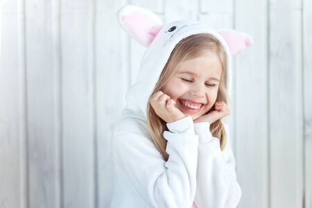 Girl in white hood is gigglingの写真素材