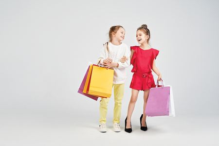 Laughing girls with shoppers bagsの写真素材