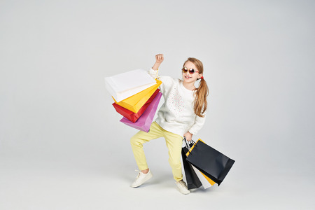 Girl is posing with shoppers bagsの写真素材