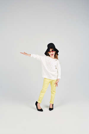 Girl in a hat is standing in the poseの写真素材