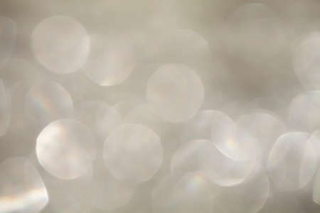 Abstract silver circular bokeh background of christmas lightの写真素材