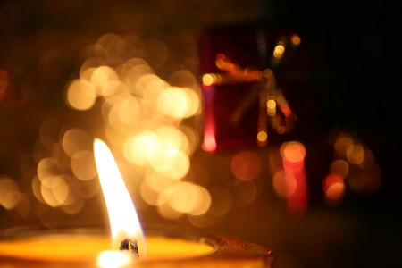Candles in Christmas and New Year Black backdrop and golden bokeh in the background.の写真素材
