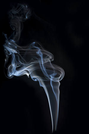 Gray incense smoke on a dark backgroundの写真素材