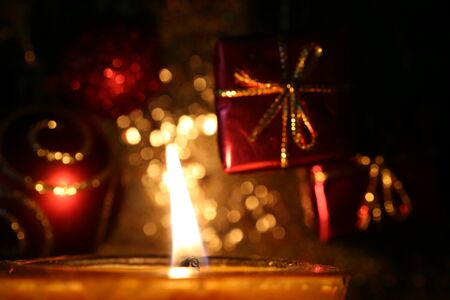 candle at Christmas with blurred golden lightsの写真素材