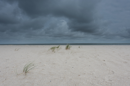 dark storm clouds on the sandy beach on Syltの写真素材
