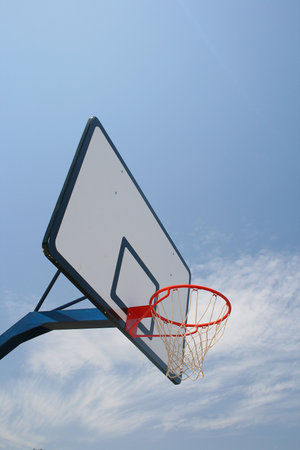 Basketball hoop, street basketball under clear blue sky
