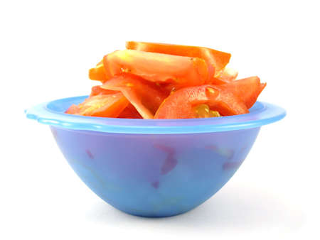 tomato salad in blue bowl isolated on whiteの写真素材