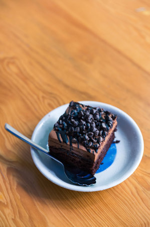 Dark chocolate cake on wood table