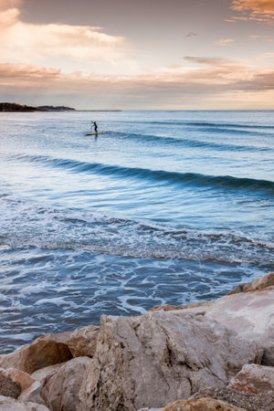 Silhouette of woman engage stand up paddle surf on sunsetの写真素材