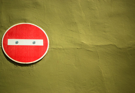 No entry sign attached to yellow brown painted wallの写真素材