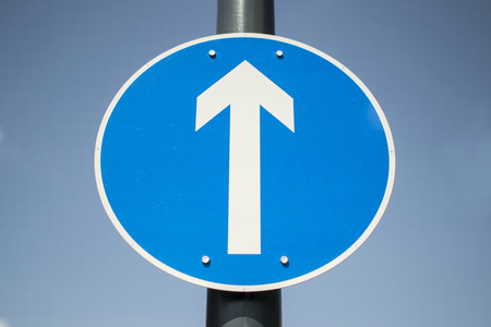 Blue 1 way sign arrow showing ahead onlyの写真素材