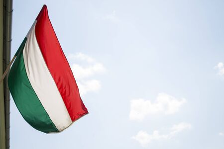 hungarian flag flying from building in light breezeの写真素材