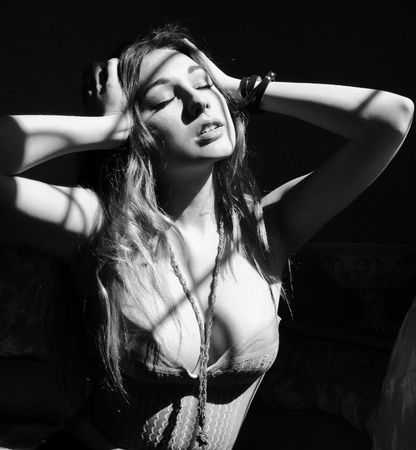 Black and white photo of attractive sensual young woman with long hair, seductive female on luxury photo shootの写真素材