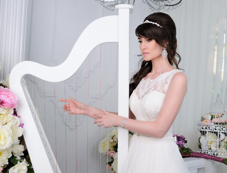 Close up of beautiful woman with harp wearing shiny diamond earringsの写真素材