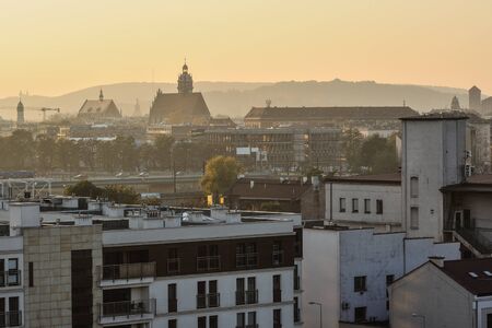 Background of buildings roofs at  sunset time, architecture, sunny hazeの写真素材