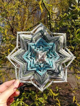 Woven colourful handcrafted yarn God's eye mandalaの写真素材