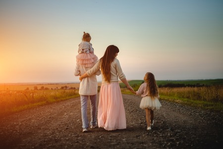 parents and children outdoor at sunsetの写真素材
