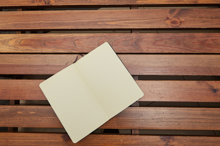 Open Notepad or sketchbook is a wooden table. workspaceの写真素材