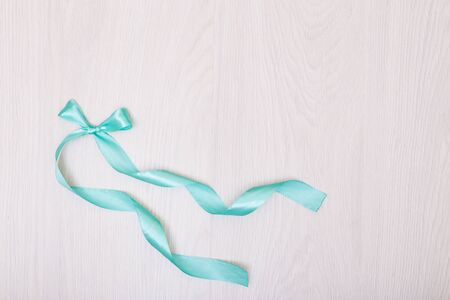 Blue ribbon on a background. Creative mock up Empty table and blue ribbon bowの写真素材