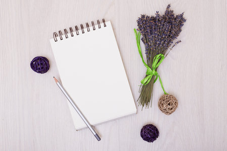 Lavender flowers and empty photo album book cover. Floral frame from dried plants. Flat lay...