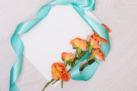 Creative mock up layout made of roses  with copy space on table homemade flat lay. Empty sheet of...