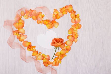 Flowers composition heart symbol made of dried flowers and leaves top view flat lay. Heart of rose petalsの写真素材