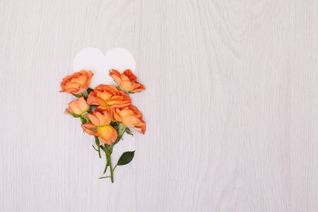 Creative mock up layout made of roses  with copy space on table homemade flat lay. Empty sheet of heart card. a blank piece of paper. ribbonの写真素材