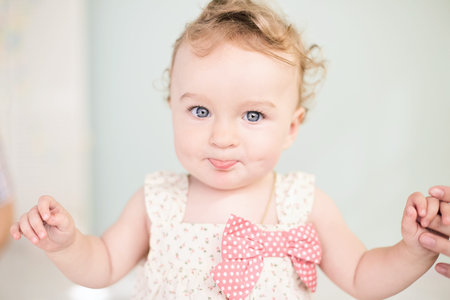 Happy little child girl sit on white towel happy emotion and face expression