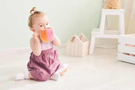 little child is playing with toys in the studioの写真素材