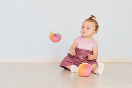 little child is playing with toys in the studio