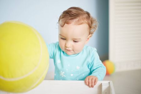 little child is playing with toys in the studioの写真素材