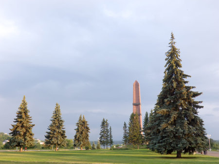 Photo of the Monument of Friendship a sunny day on a background of the blue sky and fur-trees. The city of Ufa, Russia. It can be used as a backgroundの写真素材