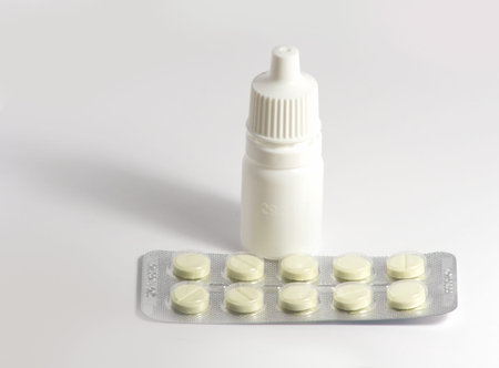 Photo of packing of tablets and bottles of mixture on a white background separately.