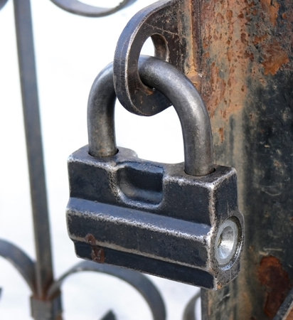The hinged iron lock close up at day time illumination