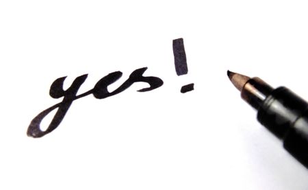 Pencil writing answer "yes". Isolated on white.の写真素材