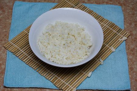 A bowl of rice on a bamboo matの写真素材