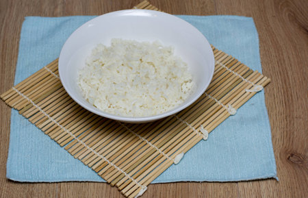 A bowl of rice on a bamboo matの写真素材