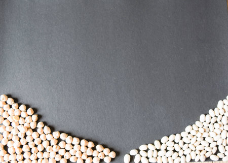 chiclpeas and haricot beans on a bottom of black backgroundの写真素材