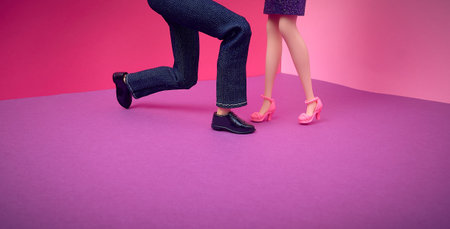 Couple, dolls. The man is standing on one knee. Pink purple background. Text space. Proposal,...