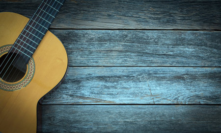 Classical guitar on a wooden background