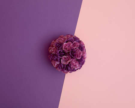 Bouquet of artificial purple roses on a two-tone light and dark violet background. Text space. Celebrations, Valentine's Day, weddings. Minimal style. Top View. Flat lay.の写真素材