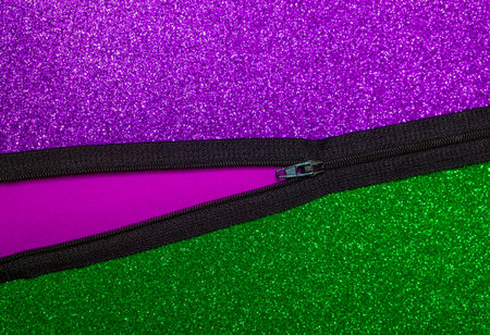 Zipper, half open. Purple and green glitter background. Text space. Top view. Abstract, message,...
