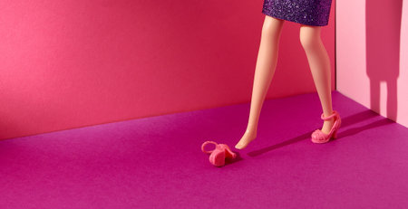Doll. A high-heeled shoe fell from her feet. Bright red pink background. Text space. Modern...