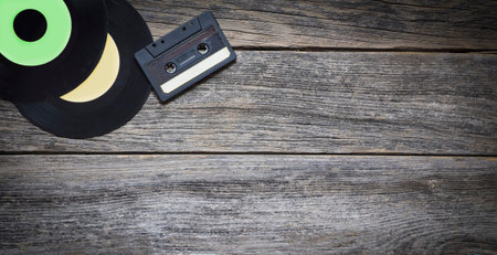 Vinyl records and audio tape on a wooden backgroundの写真素材