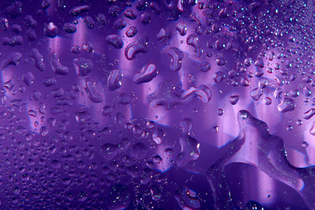 Blurred violet shiny background with water drops.の写真素材
