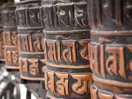 Decorated buddhist prayer wheels in a stupa. の写真素材