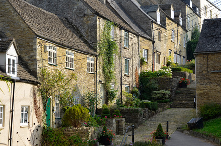 The medieval architecture of the old Cotswold cottages of the Chipping Steps in Tetbury in Gloucestershire in the Cotswolds, England.の写真素材