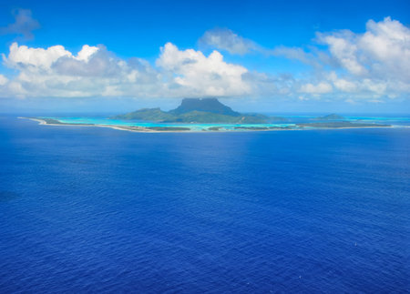 Aerial view from an airplane towards the honeymoon destination of the tropical island of Bora Bora...