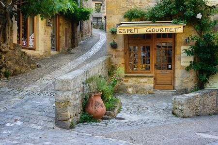 Beynac-et-Cazenac, France - August 25, 2015: Typical French townscape with a gourmet storefront and cobblestone streets in the traditional town Beynac-et-Cazenac along the Dordogne River in Perigord region, France.のeditorial素材
